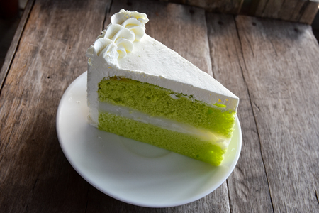 Delicious of Green tea mousse cake on wooden tableの写真素材