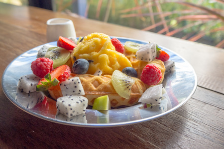 fresh healthy fruit salad on wooden backgroundの写真素材