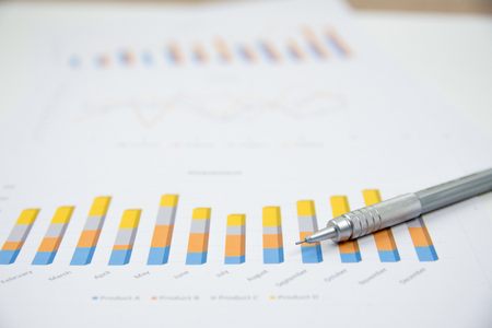 Businessman analyzing investment charts at his workplaceの写真素材