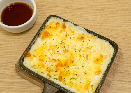 Cheese topped casserole, straight from the oven.の写真素材