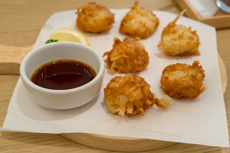 Cheese ball with tomato sauce on wooden table.の写真素材