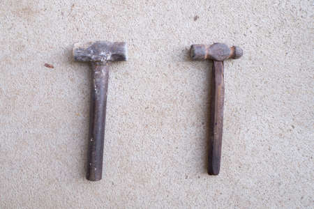 Old round metal hammer on the cement floor