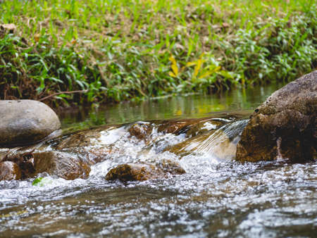 The water is flowing through the rocks.
