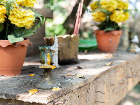 buddhist candle holder with candles flowing downの写真素材