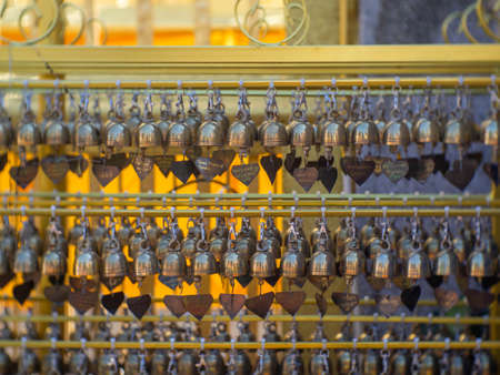 Numerous bells hanging from each other as part of Buddhism.