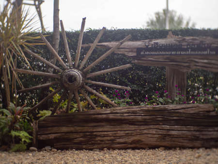 An old wooden wagon wheel was placed on the ground.
