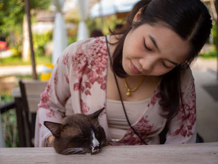 A woman wearing red dress playing in the water at Coffee shop called "Nature park", Wong Thong, Pitsanulok, Thailand.の写真素材
