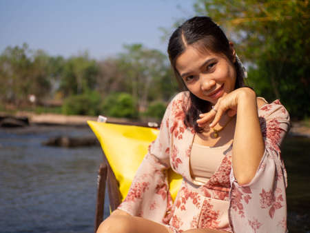 A woman sitting in a chair in the middle of the river