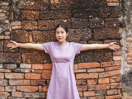 Woman wearing purple dress and old temple at Sukhothai, Thailand in  March 13 2021