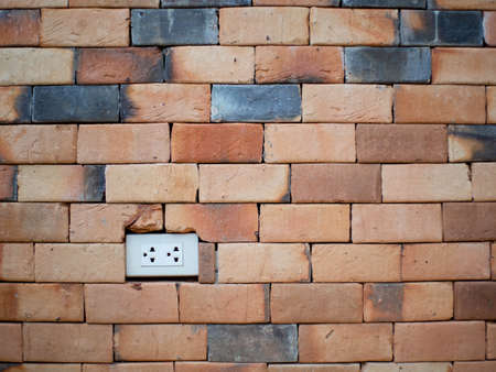 power plug and red brickの写真素材