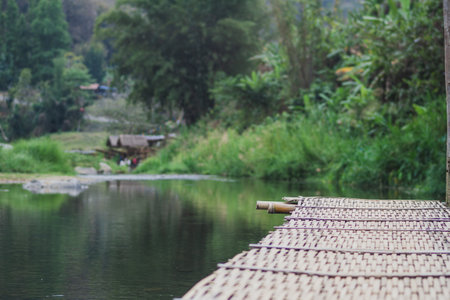 bamboo bridge and river at Utaradit, Thailand.の写真素材