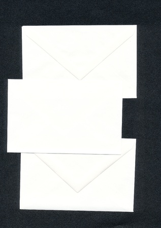 Three white envelopes, black background