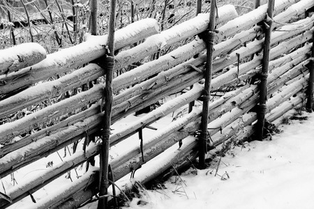 Old Swedish wooden fence in winterの写真素材
