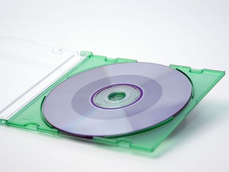 A CD-ROM in a green case on a white background.の写真素材