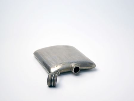 An empty silver flask from the 40s or 50s on a white background.の写真素材