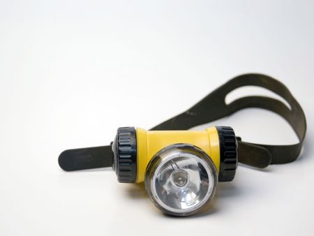 A yellow flashlight headlamp on a white background.の写真素材