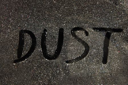 A word DUST drawn on dusty surfaceの写真素材