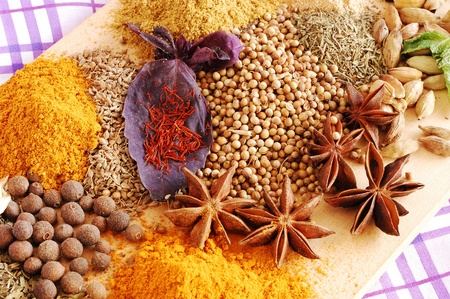 Various spices closeup (saffron, basil, coriander, star anise, thyme, cardamom, pepper, turmeric, curry powder)の写真素材