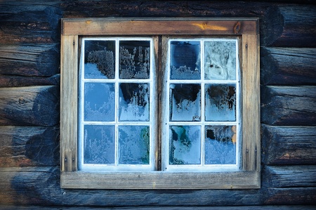 Window of a traditional Norwegian hut with frost patternsの写真素材