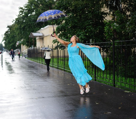 Girl flying with umbrellaの写真素材