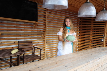 Shop assistant offering a pumpkinの写真素材