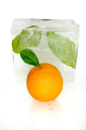 Still-life with an orange and large ice cubeの写真素材