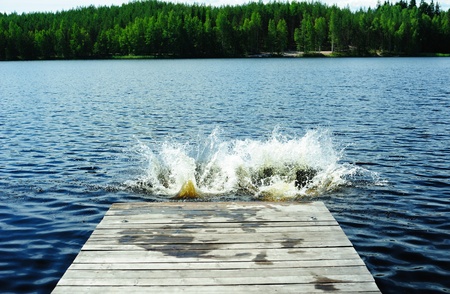 Two splashes left by people who dived from the pier on the lakeの写真素材