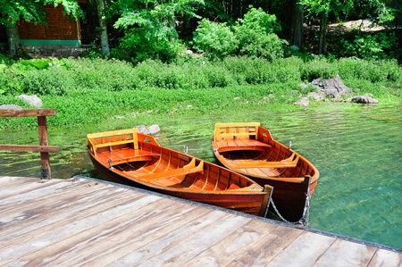 Two boats moored on a peaceful forest lakeの写真素材
