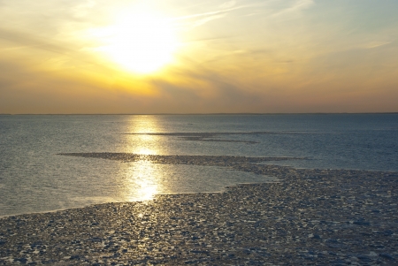 Spring icy sunset landscape of the Baltic seaの写真素材