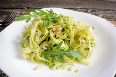 Tagliatelle pasta with pesto of rucola and pine nuts, selective focusTagliatelle with pestoの写真素材
