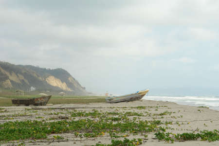 two old boats on pacific coast. canoa. ecuador. south americaの写真素材