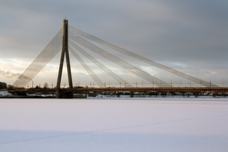 Bridge on the ropes in front of cloudy skiesの写真素材