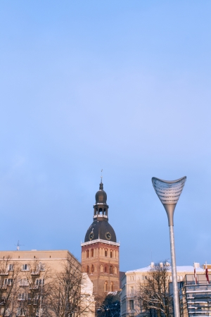 Old church in Riga behind modern streetlightの写真素材