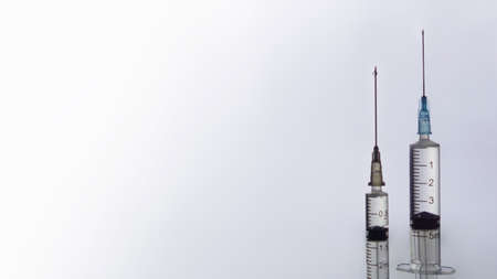 vaccination concept, syringe and glass vial with medicine for injection close-up, copy spaceの写真素材