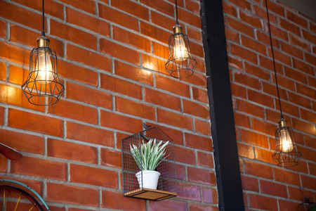 An orange light classic lamp and have a brick wall background.の写真素材