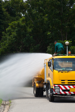 Officials are spraying water from the atomizer, On large water truck outdoorの写真素材