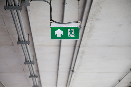 green fire Exit sign in buildingの写真素材