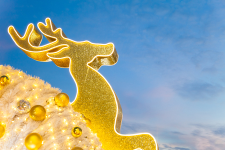 Golden reindeer are decorated beautiful objects of Christmas day and have sky in the background. Waiting for the festival day at the end of the year.の写真素材