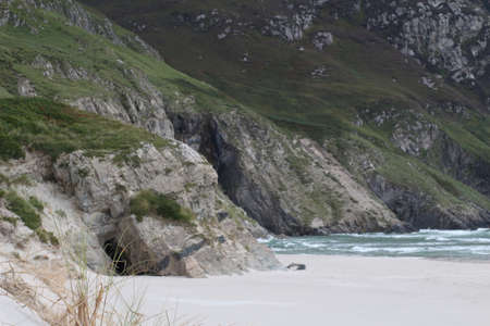 Sea water over the sand beach mountainの写真素材