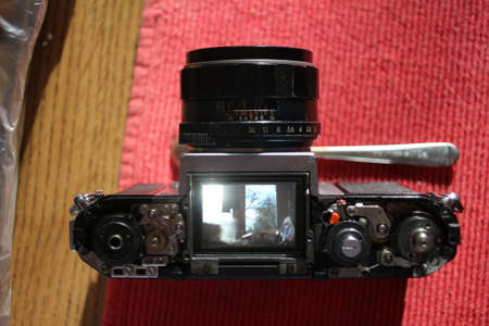 Repair old vintage camera mechanism on the red matの写真素材