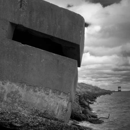 Window on the angle concrete build brick on the sea shoreの写真素材