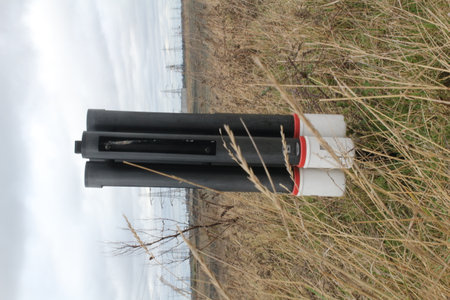 Black and white power electric cable in the yellow fieldの写真素材