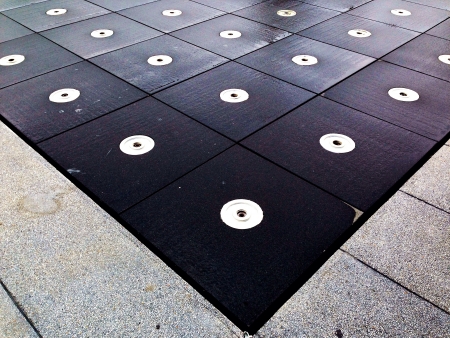 The white dot on black square on the groundの素材