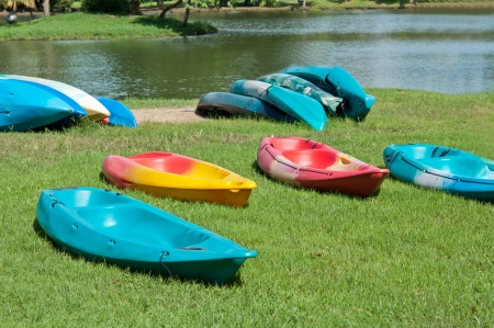 The colorful canoe on the grass near the lakeの写真素材