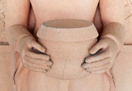 The sculpture of Buddha hold the monk's alms-bowl made from stone in Thai Styleの写真素材