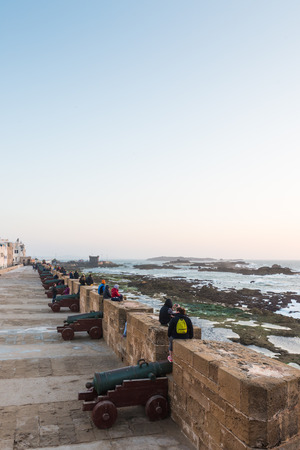 ESSAOUIRA, MOROCCO - MAR 13: The tourist at the Skala de la Ville near the sea waiting for the sunset on March 13, 2014 in Essaouira, Moroccoのeditorial素材