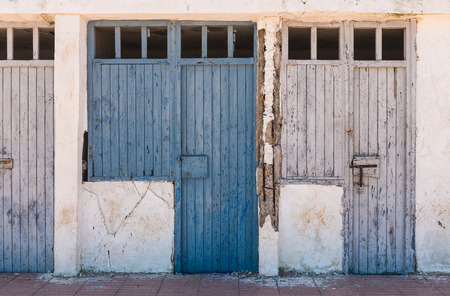 The old blue doors of the deserted room as background at the beach in El Jajida, Moroccoの写真素材