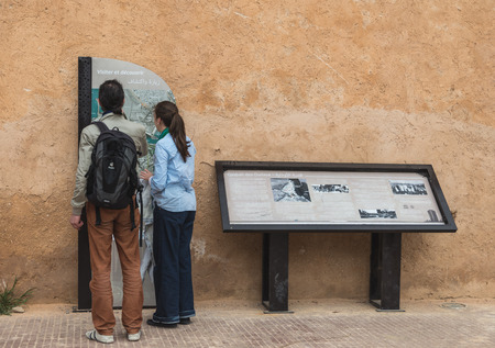 Rabat, Morocco - Mar 20, 2014: Two tourists read guiding map of Kasbah of the Udayas or Qasban des Oudaya on March 20, 2014 in Rabat, Moroccoのeditorial素材