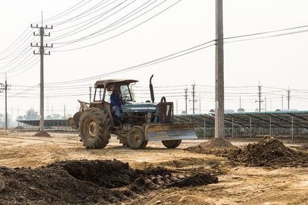 Petchaburi, Thailand - February 20, 2016: One worker drives wheel dozer in the under construction...