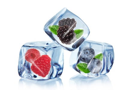 Berries in Ice cubes over whiteの写真素材